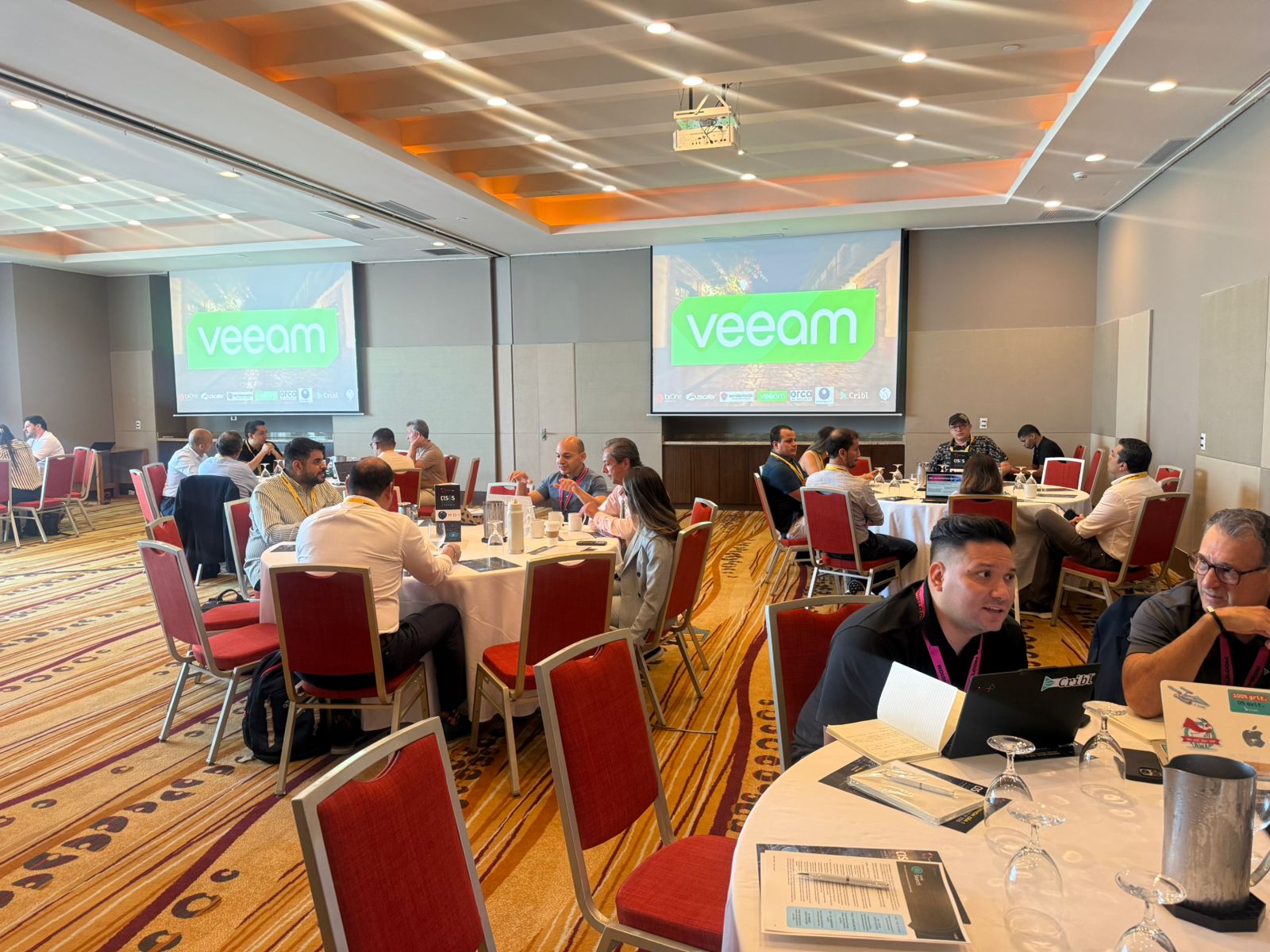 Executive delegates seated at roundtables during the morning plenary session